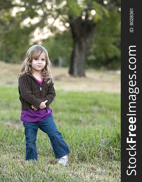 Girl in Field with a tree in depth of field