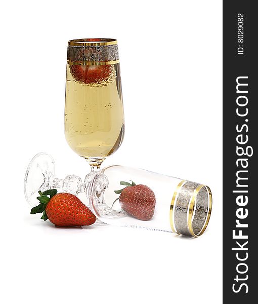 Glasses with champagne and a strawberry.