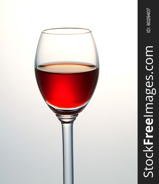 Small glass filled with red liquor. Small glass filled with red liquor