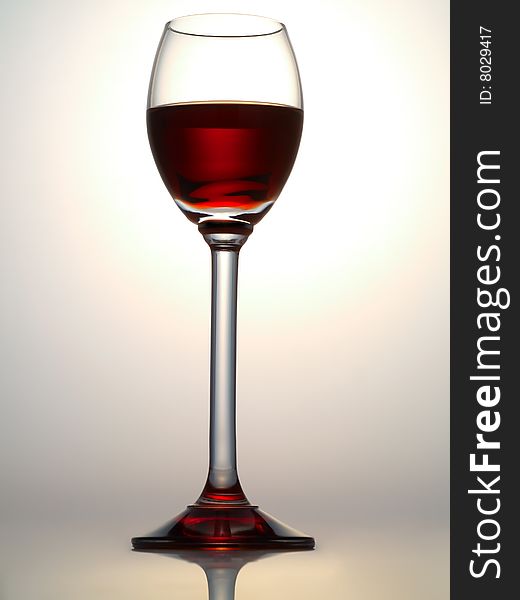 Small glass filled with dark red liquor. Small glass filled with dark red liquor