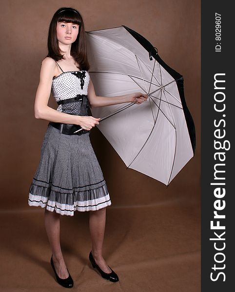 Girl holding an umbrella in studio. Girl holding an umbrella in studio