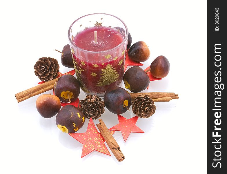 New Year's candle in an environment of apples, strobiles und stars on white background