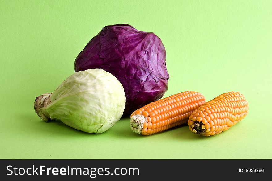 Corn and cabbage cloe-up isolated on a green background