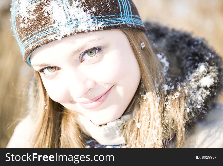 Woman Close-Up Portrait On The Winter Background. Woman Close-Up Portrait On The Winter Background
