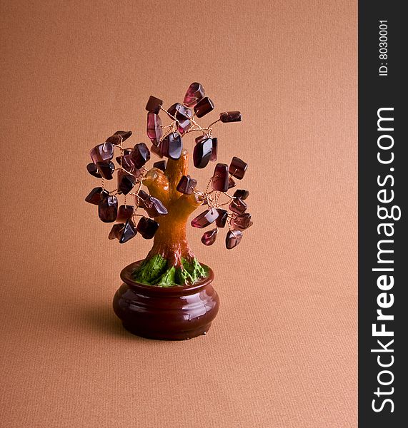 Semiprecious stones tree cose-up isolated on a red background