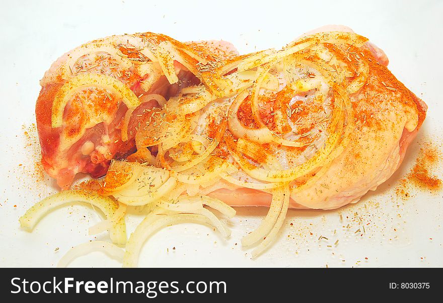 Raw chicken with spices isolated on white background