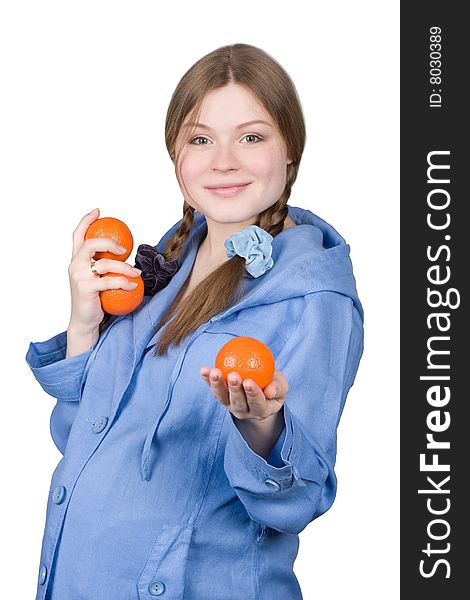 Fine pregnant woman in blue holding three oranges on white background