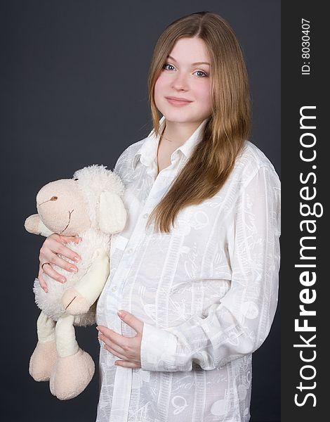 Beautiful Pregnant Woman Holding Toy