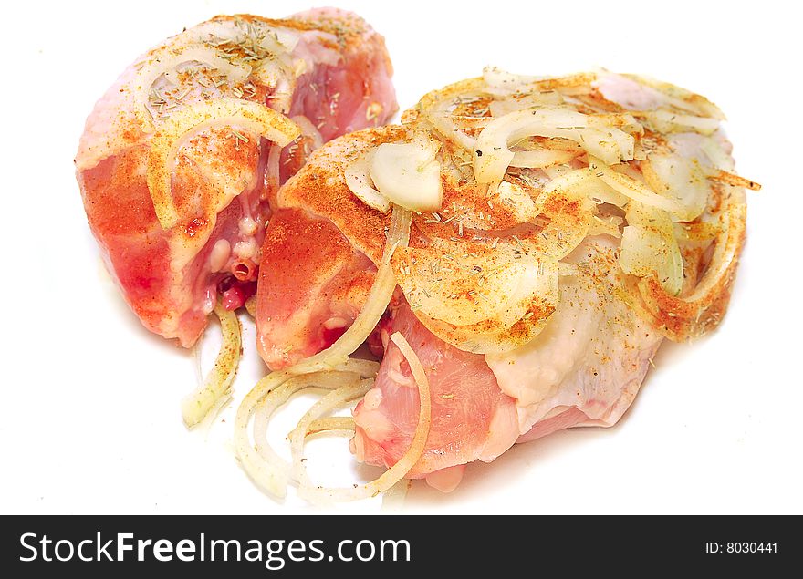 Raw chicken with spices isolated on white background