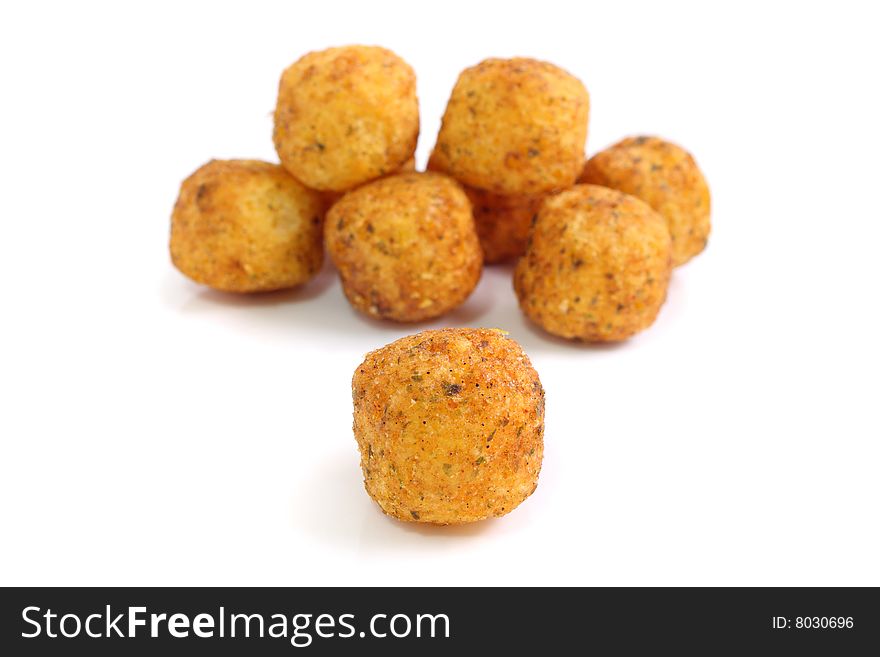 Close up of many snack balls over white background.