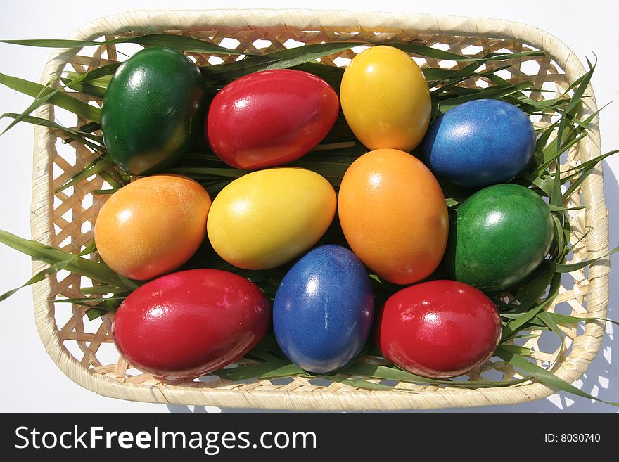 Easter eggs with different color on a basket