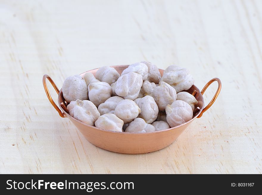 Picture of frying pan isolated in background of wood with chickpea. Picture of frying pan isolated in background of wood with chickpea