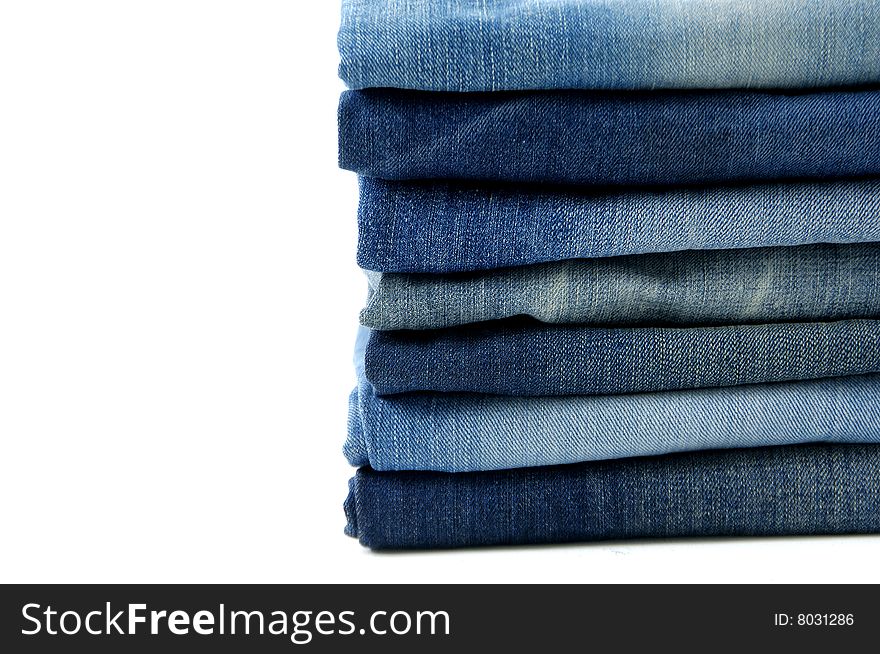 Blue jeans and trousers on hangers