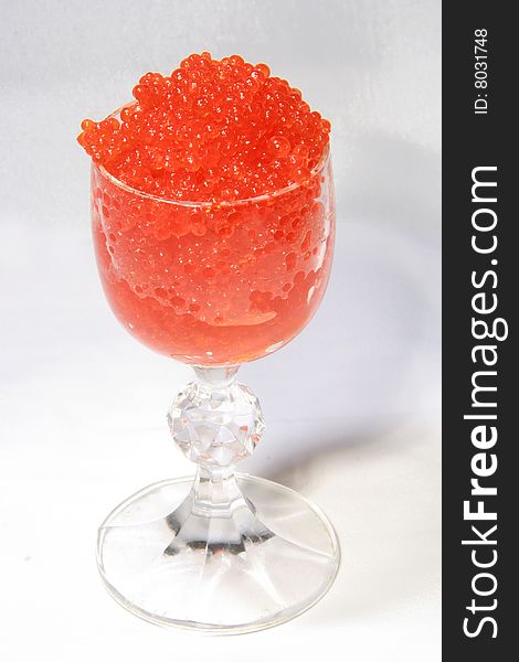 Red caviar in glass. Softbox light.