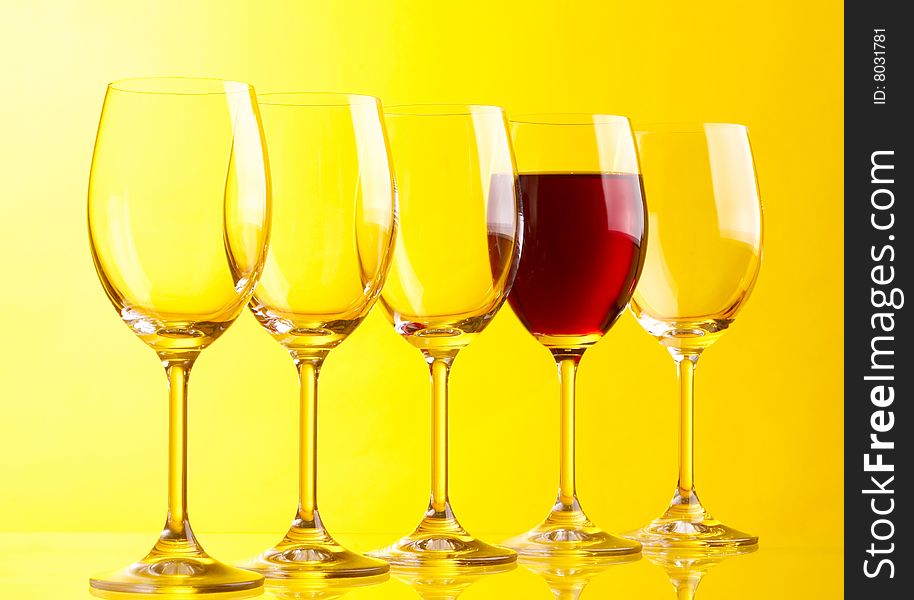 Wine glasses on yeloow background