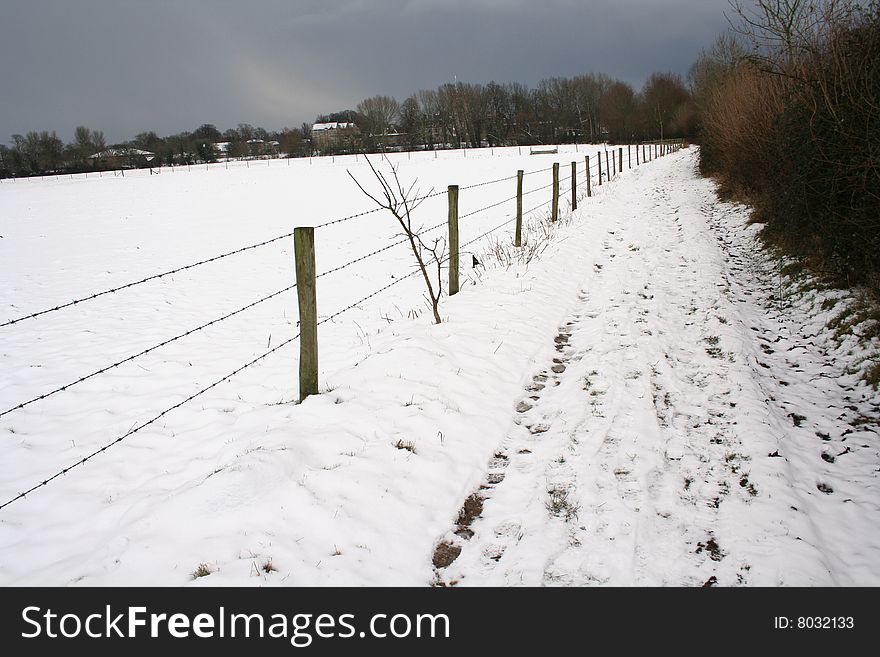 Field of snow, with barbed fence and path. Field of snow, with barbed fence and path
