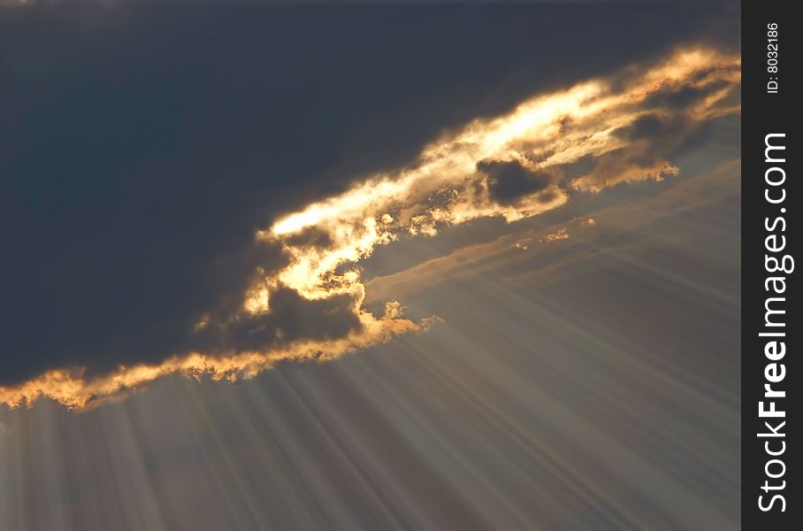 Dark dramatic sky with sun rays