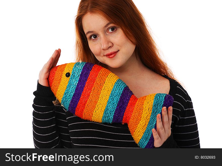 The young woman with a toy rainbow fish on a white background