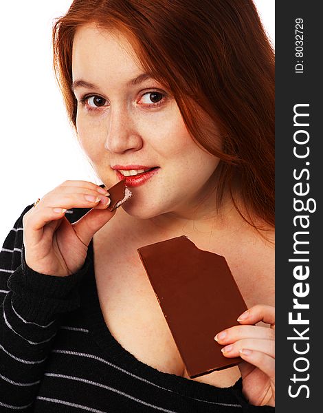 The young beautiful woman with a chocolate on a white background