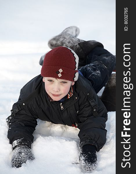 A boy falling down in snow. A boy falling down in snow