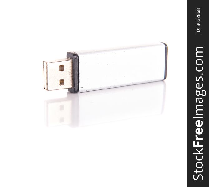 Isolated shot of a silver USB stick. The stick is mirrored and isolated over pure white. Lot of copyspace.