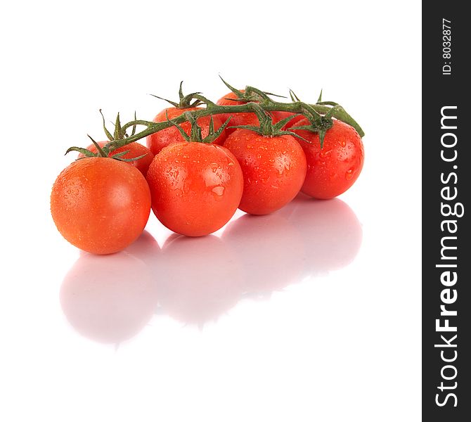 Macroshot of a bunch of tomatoes with drops of water. Isolated over white background. Lot of copyspace. Macroshot of a bunch of tomatoes with drops of water. Isolated over white background. Lot of copyspace.