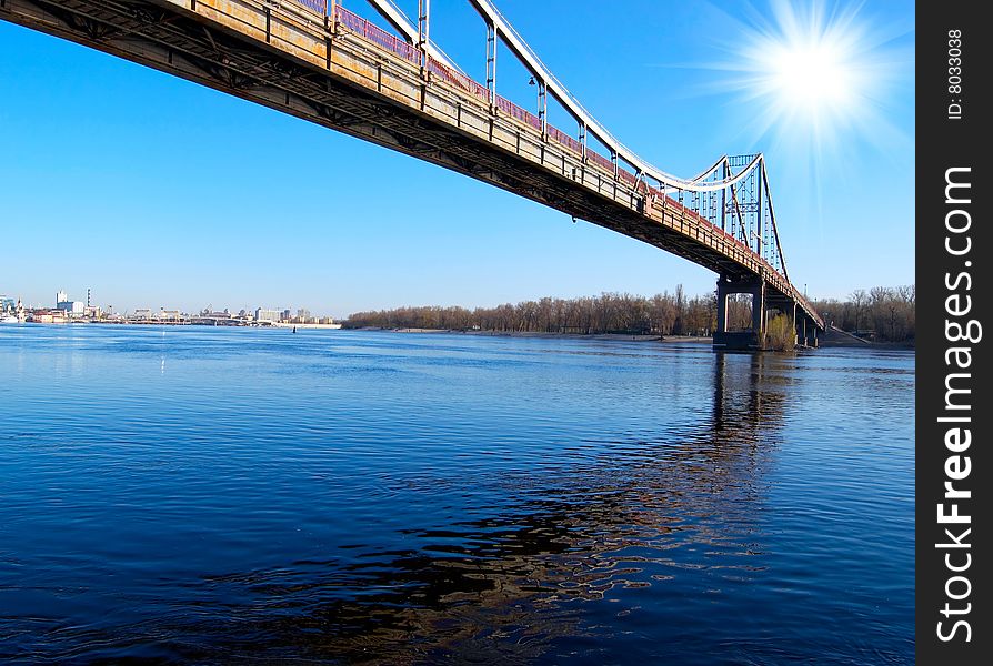 Bridge over blue river on sunny day