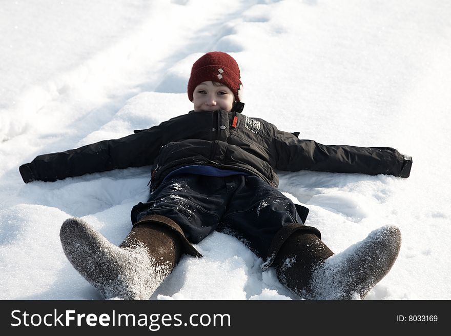 A boy falling down in snow. A boy falling down in snow