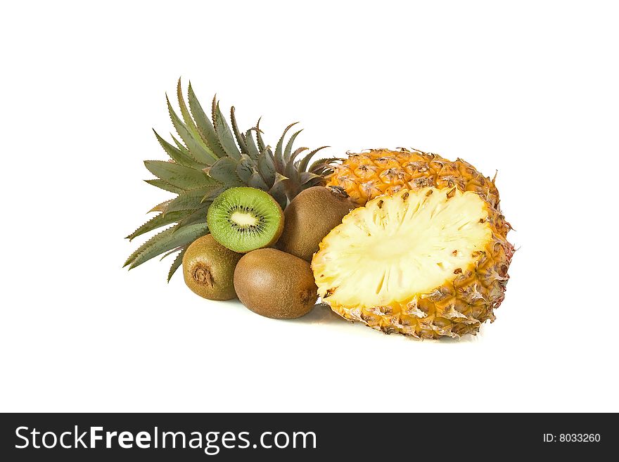 Whole and halved pineapple and Kiwi fruit against a white background