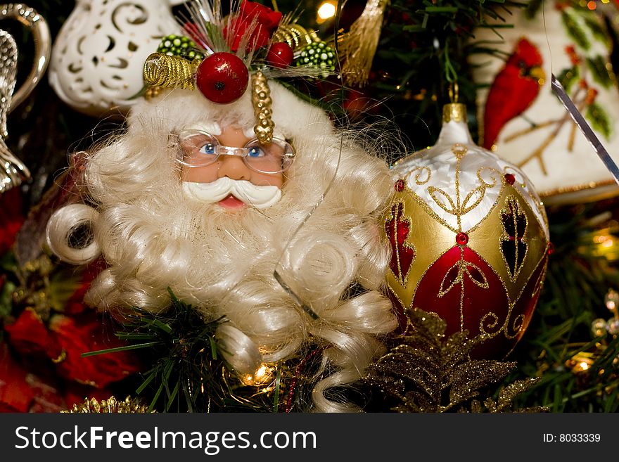 A nicely decorated christmas tree with a Santa Claus ornament. A nicely decorated christmas tree with a Santa Claus ornament