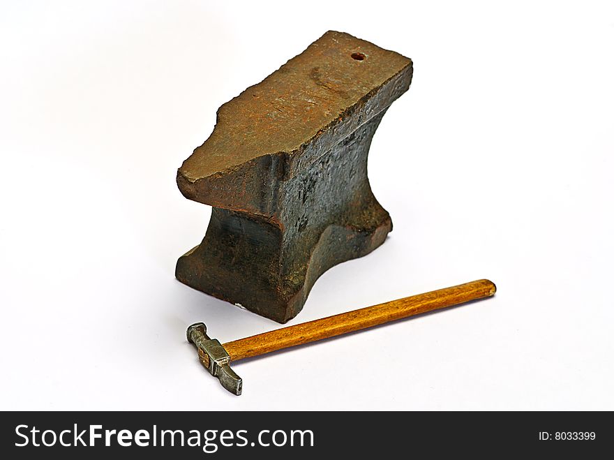 Old anvil and hammer on white