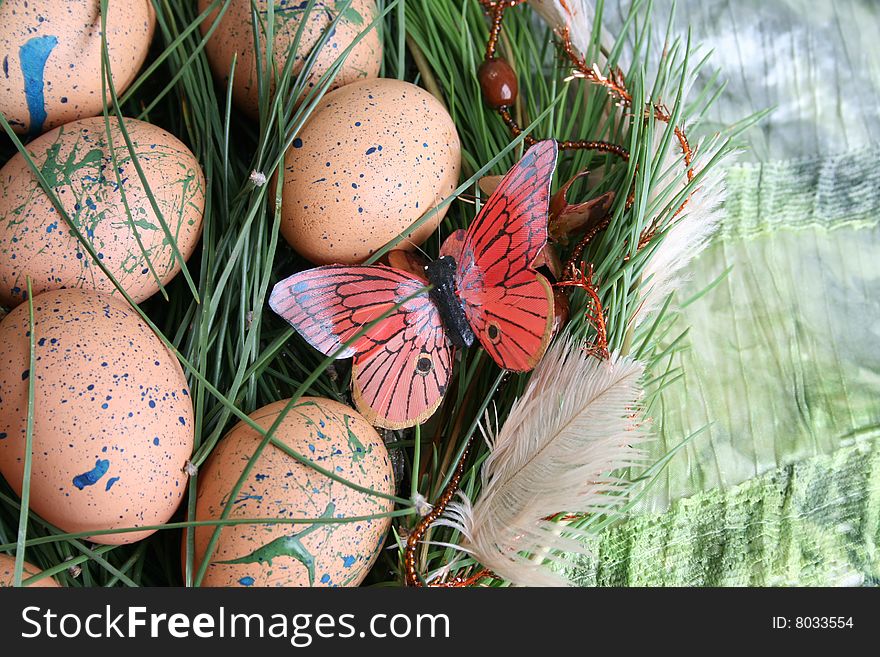 Decorated eggs in a wreath on a green background. Decorated eggs in a wreath on a green background