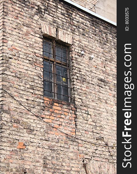 An old brick wall with a window