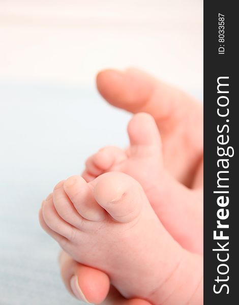 Feet of a baby in his mothers hand. Feet of a baby in his mothers hand