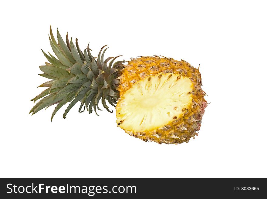 Whole and halved Pineapple against a white background