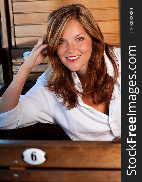 Young woman sitting in train and smiling