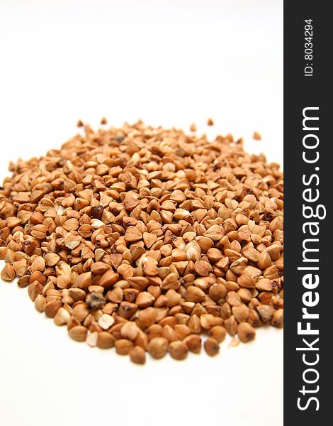 Seeds of buckwheat on white background