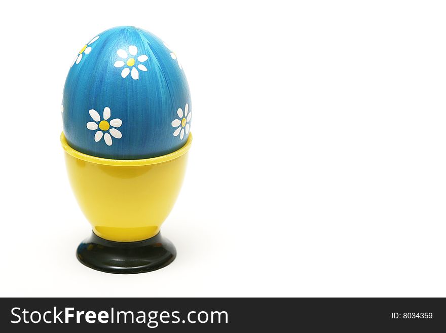 Easter blue egg with white flower on white background.