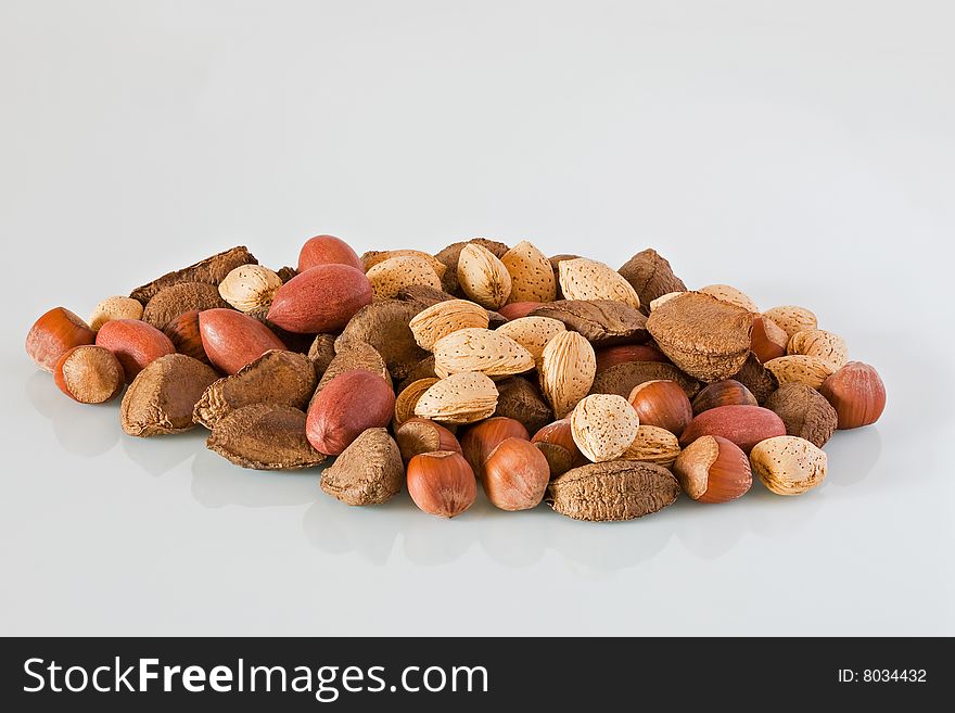 Pile of mixed nuts against a grey background
