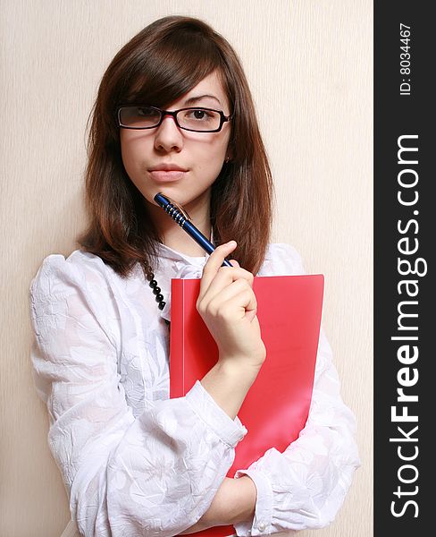 Portrait of the business woman in a white blouse and a folder of documents. Portrait of the business woman in a white blouse and a folder of documents.