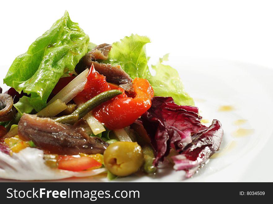 Salad with Anchovy, Olive and Vegetable Leaf. Isolated on White Background