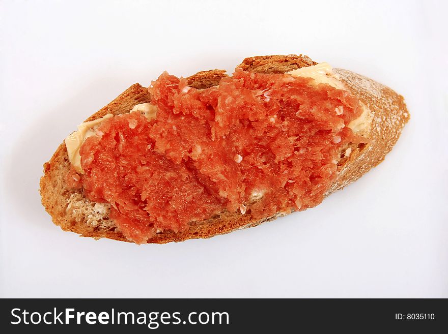 Slice of french bread with minced meat and butter