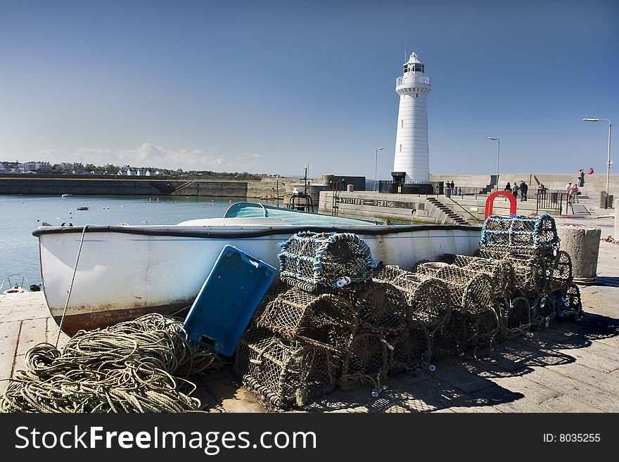 Picture of a busy port with a light house