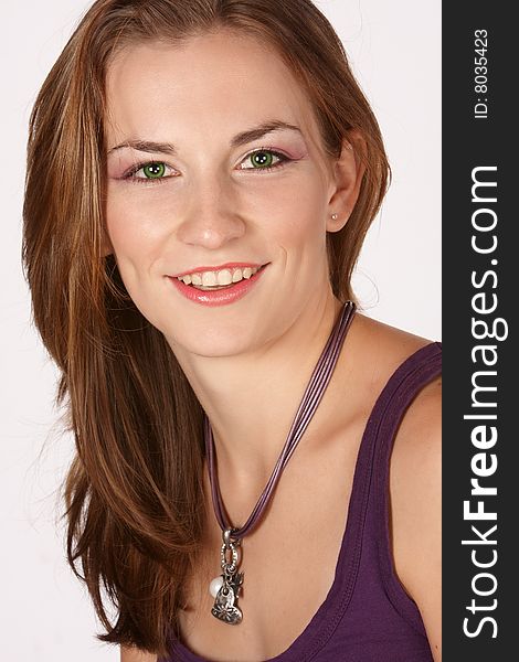 Young model with big smile, purple top and long brown hair. Young model with big smile, purple top and long brown hair