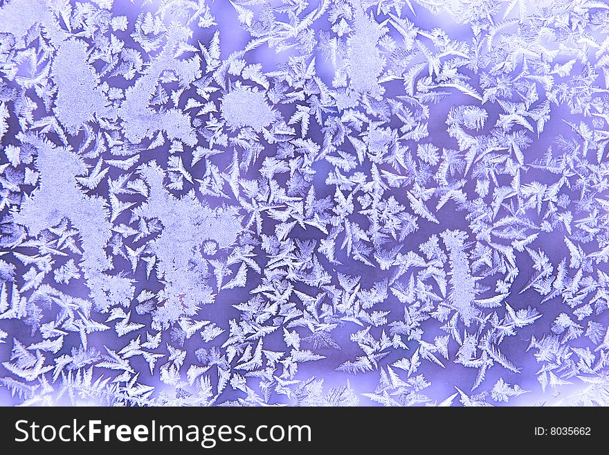 Frostwork on a window glass (as an abstract winter background)