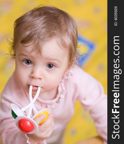 Little girl playing with rattle - shallow DOF