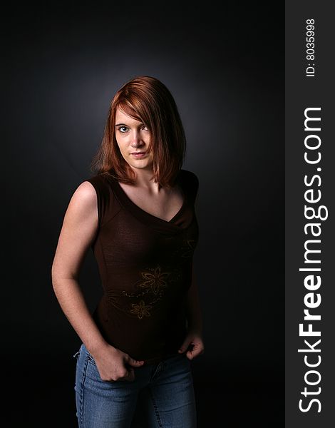 Pretty red headed teenage girl in dark shirt