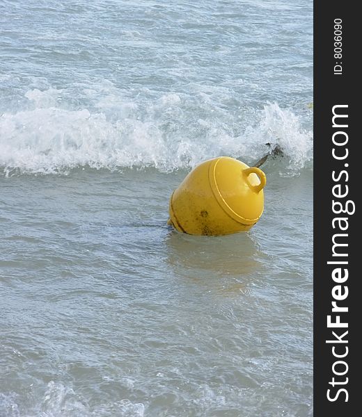 Yellow surface marker buoy in mediterean sea