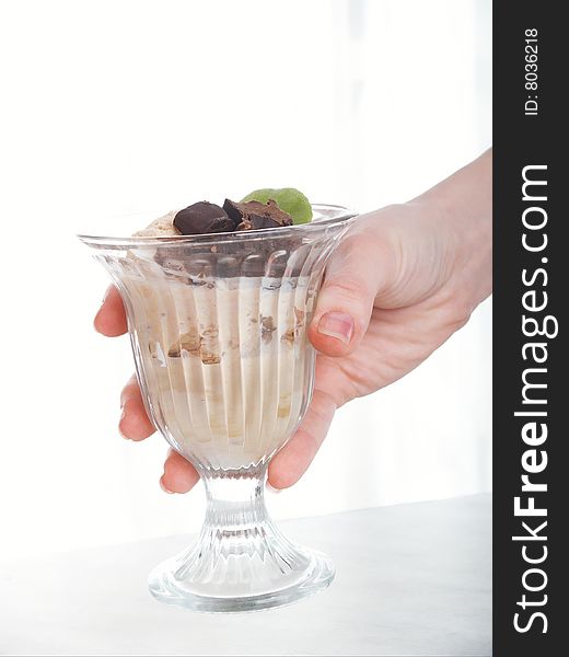 Vase with ice-cream on background