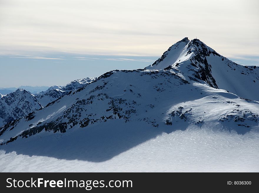 A view of winter Alps peaks in the sun in Stubai area. A view of winter Alps peaks in the sun in Stubai area.